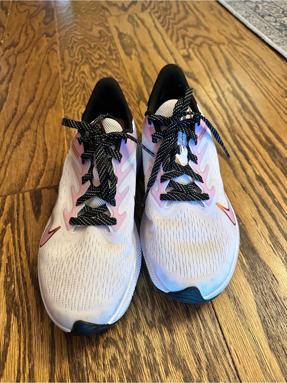 Nike Women's White Running Shoes with Pink Accents and Black Laces
